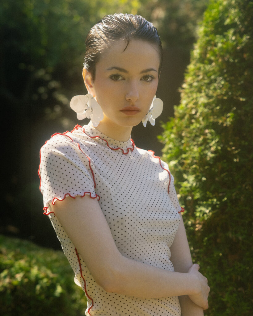 model Eva Lou of System Agency Montreal in a manicured garden, styled by Uyen Dao, hair and makeup by Gabbie Mcguire and photographed by Megane Brunette