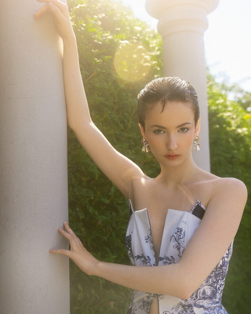 model Eva Lou of System Agency Montreal in a manicured garden, styled by Uyen Dao, hair and makeup by Gabbie Mcguire and photographed by Megane Brunette