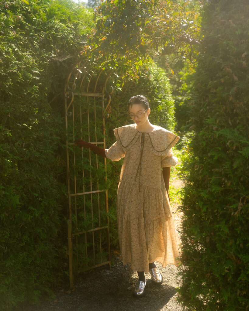 model Eva Lou of System Agency Montreal in a manicured garden, styled by Uyen Dao, hair and makeup by Gabbie Mcguire and photographed by Megane Brunette