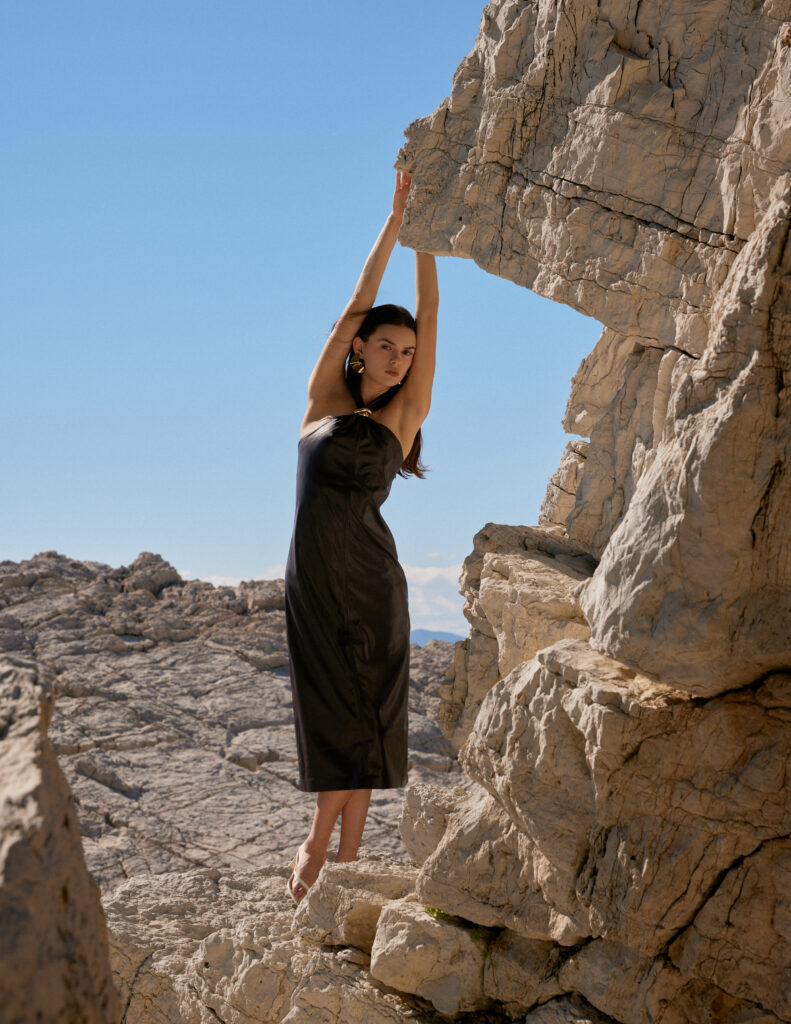 Model Elisa Bardoux of Enjoy Models Agency posing amongst large rock formations on a sunny day on the French Riviera photographed by Mégane Brunette