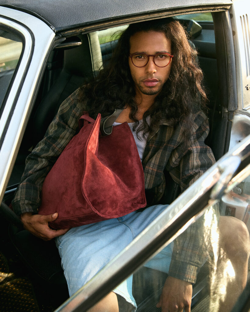 In a FW25 photoshoot for eyewear company Bonlook, model Daouda Ka of Folio management wearing a western inspired outfit, sitting in a vintage car. Shot in the Canadian West. Styled by Gabriel Dupuis, hair and makeup by Nicole Saxton and photographed by Megane Brunette.