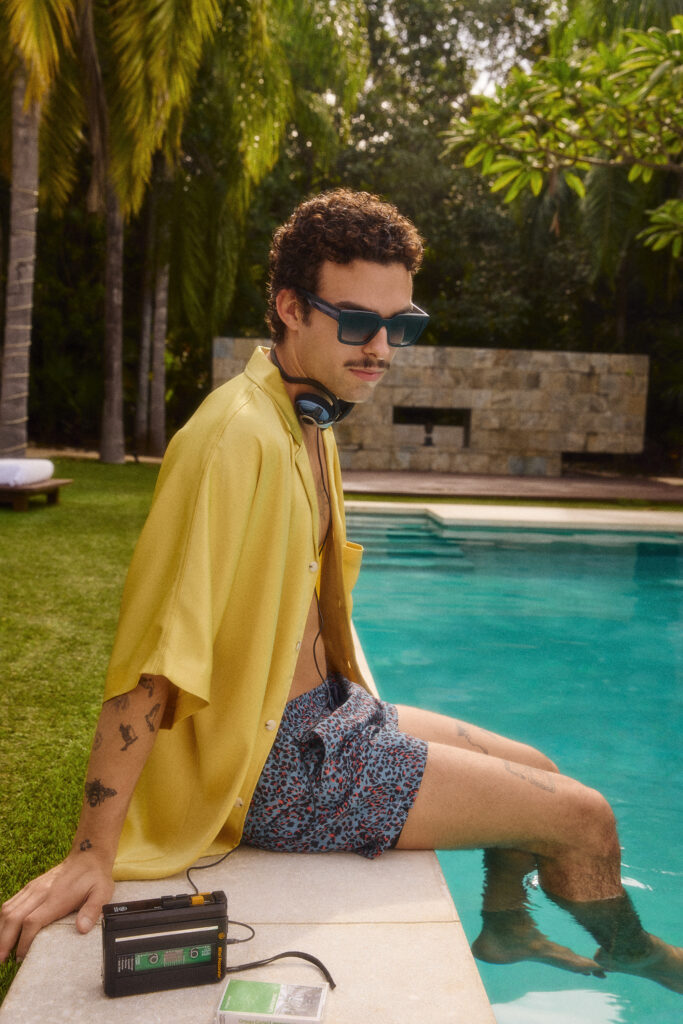 In a SS26 photoshoot for eyewear company Bonlook, model Gabriel Lebleu of Humankind Management sitting by a pool in Mexico. Styled by Gabriel Dupuis, hair and makeup by Mayillah, photographed by Megane Brunette.