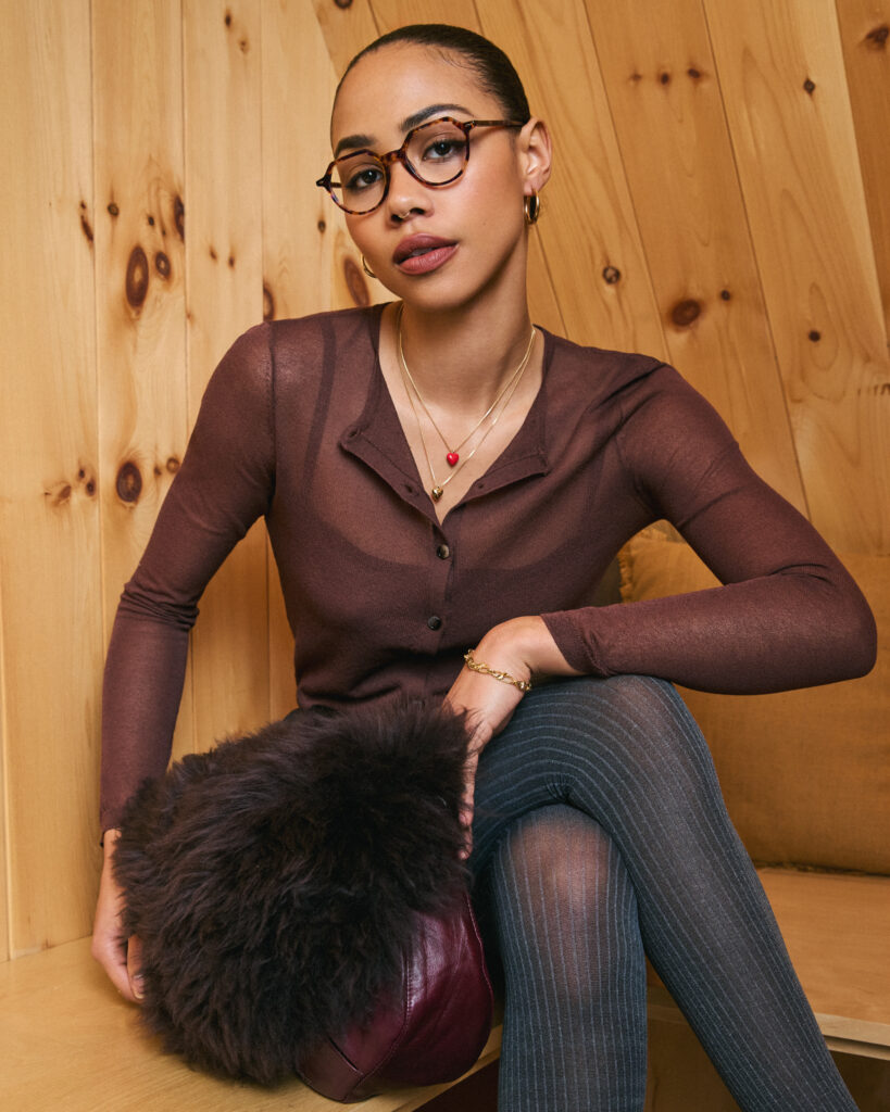 In a Holiday photoshoot for eyewear company Bonlook, model Trinity Faith of Folio Management sitting in a wooden chalet. Styled by Gabriel Dupuis, hair and makeup by Genevieve Lenneville of Folio Management, photographed by Megane Brunette.
