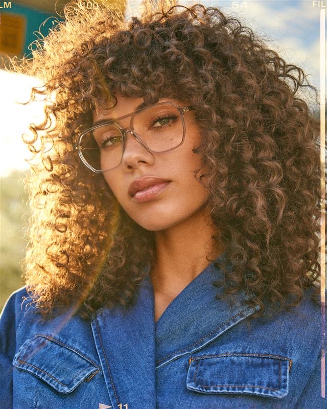 In a FW24 photoshoot for eyewear company Bonlook, model Ashley Jean McDonald of Elite Models Toronto. The sun is shinning from behind her. Styled by Olivia Leblanc, hair and makeup by Genevieve Lenneville and photographed by Megane Brunette.